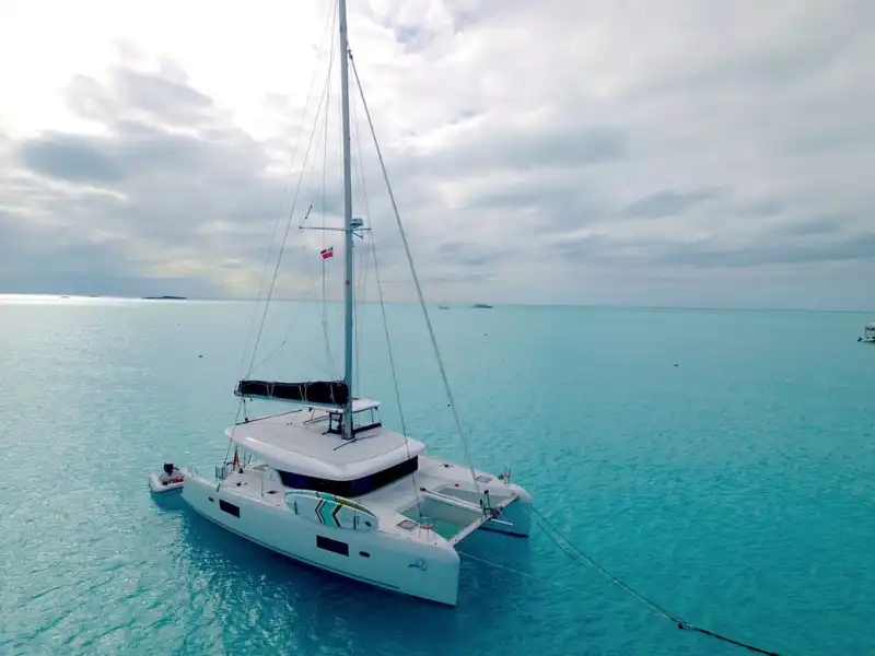 Lagoon 42 catamaran at anchor in a calm, shallow bay